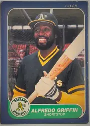 Front of 1986 Fleer Alfredo Griffin #417 Base, front of a Fleer baseball card. A full-color action-style portrait fills most of the card: a smiling Black player with a beard wearing a dark…