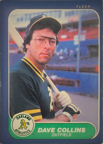 Front of 1986 Fleer Baseball Cards Dave Collins #415 Base, portrait baseball card front. A color photograph shows Dave Collins in an Oakland Athletics uniform and cap holding a bat, with a blurred ballpark…
