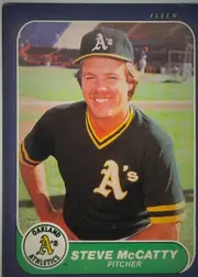 Front of 1986 Fleer Baseball Cards Steve McCatty #427 Base, front of a Fleer baseball card. A navy border surrounds a rounded-corner action/portrait photograph of a smiling player in an Oakland Athletics cap…