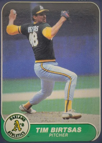 Front of 1986 Fleer Baseball Cards Tim Birtsas #412, portrait-oriented baseball card front. A color photograph shows a pitcher in an Oakland Athletics uniform delivering a pitch. The photograph is…