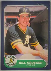 Front of 1986 Fleer Bill Krueger #424, front of a baseball card. A color action/portrait photo fills most of the card showing a smiling pitcher in a dark green-and-gray Oakland Athletics…