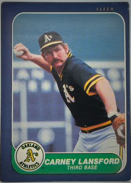 Front of 1986 Fleer CARNEY LANSFORD #426 Base, upright portrait baseball card front. A color action photograph shows a mustached Oakland Athletics player in a black-and-yellow uniform throwing a…