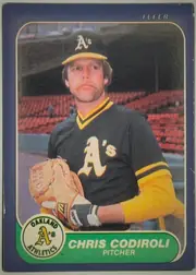 Front of 1986 Fleer Chris Codiroli #414, front of a baseball card. A full-color action/portrait photo fills most of the card: a mustached player in an Oakland Athletics black cap with…