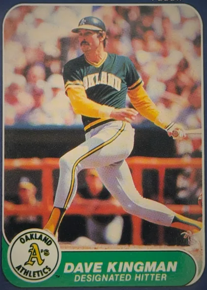 Front of 1986 Fleer DAVE KINGMAN #423 Base, portrait baseball card front showing a player in an Oakland Athletics uniform running on the field. The image fills most of the card within a…