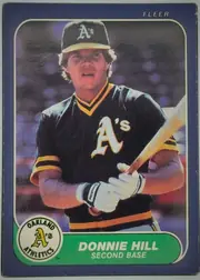 Front of 1986 Fleer Donnie Hill #420, portrait baseball card front. A player in an Oakland Athletics uniform is shown holding a bat. The top right has the white FLEER logo. The bottom…
