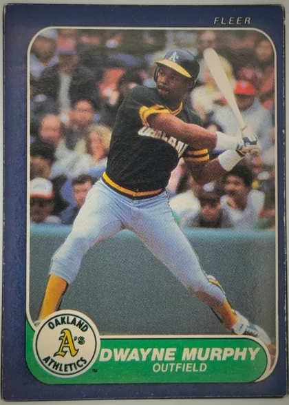 Front of 1986 Fleer DWAYNE MURPHY #428 Base, front of a vintage Fleer baseball card. A full-color action photograph shows a right-handed batter in an Oakland Athletics home uniform (dark green…