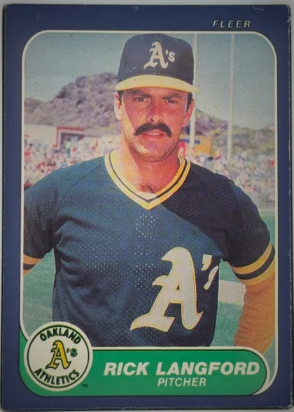 Front of 1986 Fleer RICK LANGFORD #425 Base, portrait baseball card front. A color photograph shows Rick Langford in an Oakland Athletics uniform and cap, centered against a stadium background…