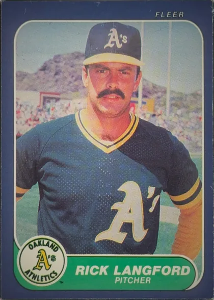 Front of 1986 Fleer Rick Langford #425 Base, portrait baseball card front. A centered photograph shows a mustached Oakland Athletics pitcher in uniform and cap, with a stadium background. The…
