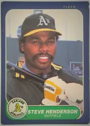 Front of 1986 Fleer Steve Henderson #419 Base, front of a Fleer baseball card. A dark blue border surrounds a rounded-corner color photograph of a smiling Black man wearing a dark Oakland…