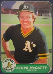 Front of 1986 Fleer Steve McCatty #427 Base, upright portrait-oriented baseball card front. A smiling Oakland Athletics player in a black-and-gold uniform and cap fills the photograph, with a…