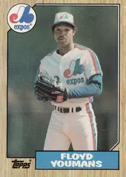 Front of 1987 Topps Baseball Floyd Youmans • Pitcher #105 Base, portrait baseball card front. A Montreal Expos player is pictured standing in uniform against a dark green-gray background. The circular Expos logo…
