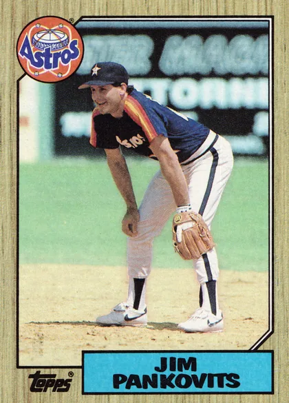 Front of 1987 Topps Baseball Jim Pankovits #249 Base, portrait baseball card front. A color photograph shows Jim Pankovits pitching in a Houston Astros uniform. The upper-left corner contains a large…