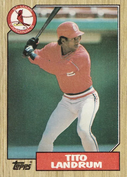 Front of 1987 Topps Baseball Tito Landrum #288 Base, upright portrait baseball card front. A full-height color action photograph shows a Cardinals outfielder in a red home uniform, white pants and red…