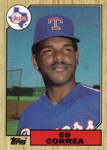Front of 1987 Topps Ed Correa #334 Base, upright portrait baseball card. A large color portrait of a Texas Rangers player fills most of the card against a blue-green background. The…