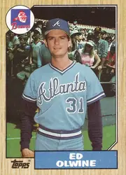 Front of 1987 Topps Ed Olwine #159 Base, portrait-oriented baseball card front. A color photograph shows a Braves player in a light blue uniform with the number 31, standing on a field with…