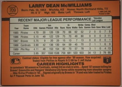 Back of 1989 Donruss Baseball LARRY DEAN McWILLIAMS #709, orange baseball-card back dominated by a centered gray-and-black statistics table. The player name is printed in large black type across the top…