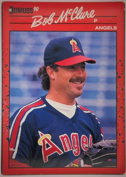 Front of 1990 Donruss Baseball Bob McClure #470 Base, portrait-oriented baseball card front. A red header and outer border surround a large color portrait of Bob McClure in an Angels uniform and cap…