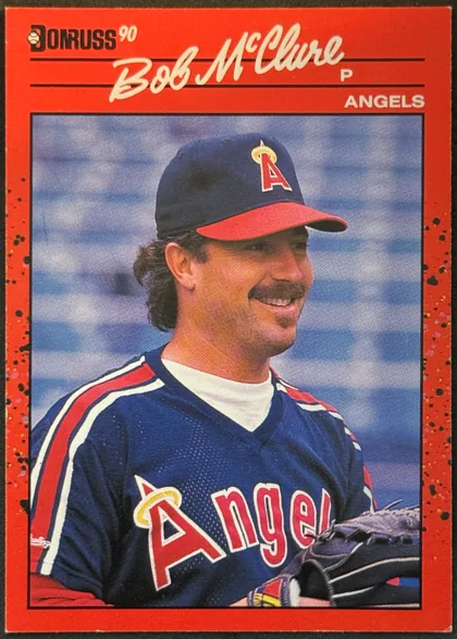 Front of 1990 Donruss Baseball Bob McClure #470 Base, portrait baseball card front. A red speckled border surrounds a large color photograph of Bob McClure wearing an Angels uniform. The Donruss logo…