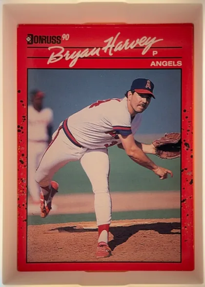 Front of 1990 Donruss Baseball Bryan Harvey #372, portrait-oriented baseball card front. A red header and border surround a large action photograph of a pitcher in an Angels uniform. The Donruss 90…