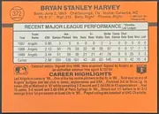 Back of 1990 Donruss Baseball Bryan Stanley Harvey #372, landscape-oriented orange baseball card back. The player's name is centered across the top, with biographical information beneath it and a circular…