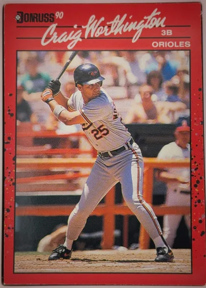 Front of 1990 Donruss Baseball Craig Worthington #141, portrait baseball card front. The upper red panel contains the black Donruss logo and white "90" at upper left, a large white script player name…