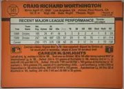 Back of 1990 Donruss Baseball Craig Worthington #141, landscape-oriented orange baseball card back. A baseball-shaped circle at upper left contains card number 141. The player name is printed…