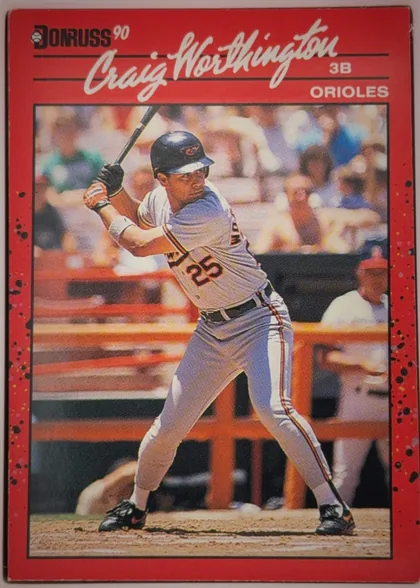 Front of 1990 Donruss Baseball Craig Worthington #141, upright portrait baseball card. The upper section has a red background with the Donruss '90 logo at upper left, a large white script player name…