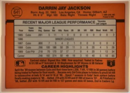 Back of 1990 Donruss Baseball Darren Jackson #641, upright landscape-oriented baseball card back. The orange-red background has the player name in large black type across the top. A baseball graphic…