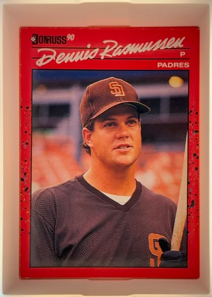 Front of 1990 Donruss Baseball Dennis Lee Rasmussen #420, portrait baseball card front. A Donruss logo and "90" appear at the upper left. The player's large white script name spans the upper section, with a…