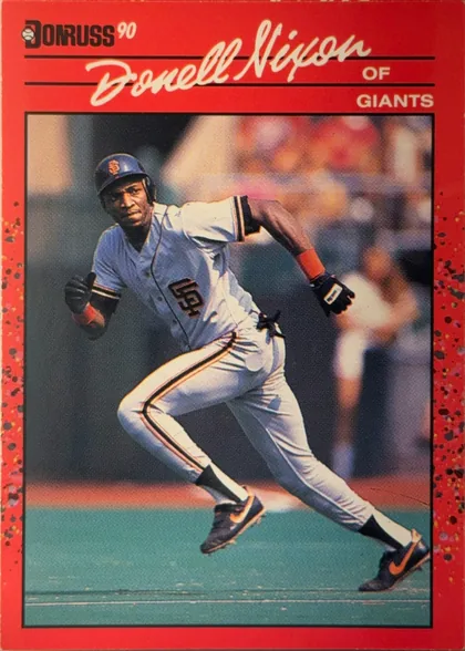 Front of 1990 Donruss Baseball Donell Nixon #571 Base, portrait-format baseball card front. A red header carries the Donruss logo and "90" at upper left, a large cream script "Donell Nixon" across the…
