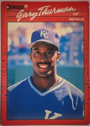 Front of 1990 Donruss Baseball Gary Thurman #416, portrait baseball card front. A large white script player name, "Gary Thurman," spans the upper portion, with "OF" and "ROYALS" printed at upper…