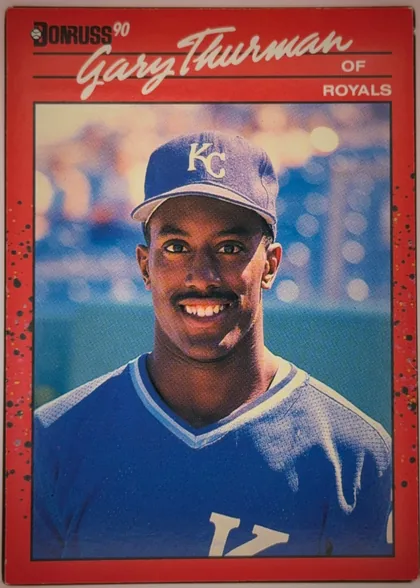 Front of 1990 Donruss Baseball Gary Thurman #416, portrait baseball card front. A large white script player name, "Gary Thurman," spans the upper portion, with "OF" and "ROYALS" printed at upper…