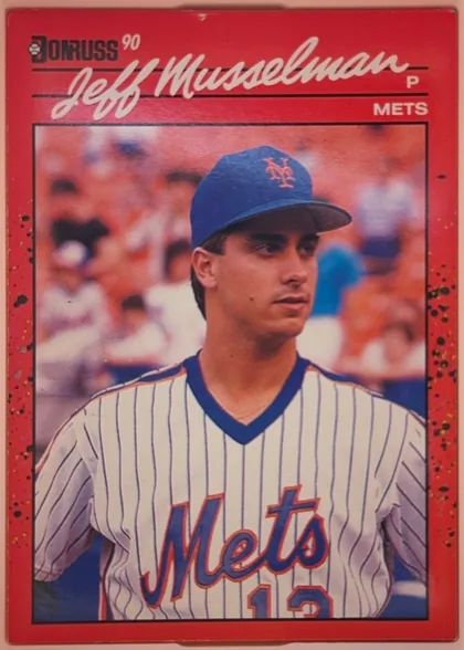 Front of 1990 Donruss Baseball Jeff Musselman #623, upright portrait baseball card. A red speckled border surrounds a black-framed color photograph of a Mets player in a white pinstriped uniform and…
