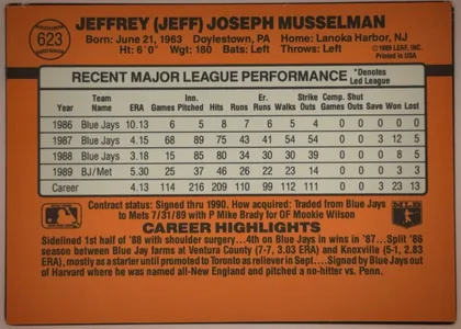 Back of 1990 Donruss Baseball Jeff Musselman #623 Base, orange baseball-card back with a large player name across the top, a baseball-shaped number emblem at upper left, biographical details beneath the…