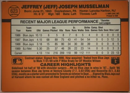 Back of 1990 Donruss Baseball Jeff Musselman #623 Base (DP), orange baseball-card back dominated by a black-printed player header across the top. A circular baseball graphic at upper left contains the number…