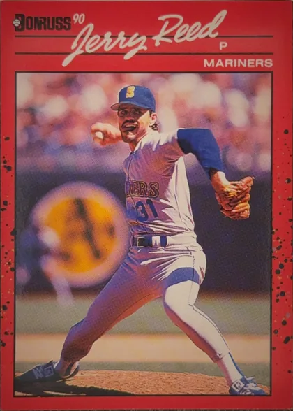 Front of 1990 Donruss Baseball Jerry Reed #614 Base, portrait baseball card front. The upper left contains the Donruss logo and "90". A large white script player name, "Jerry Reed," spans the top over…