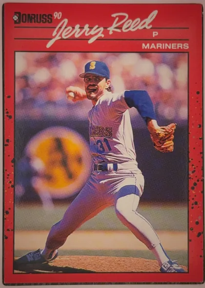 Front of 1990 Donruss Baseball Jerry Reed #614 Base, portrait baseball player card. A large white script name, "Jerry Reed," spans the upper red header. The Donruss logo and "90" appear at upper left…
