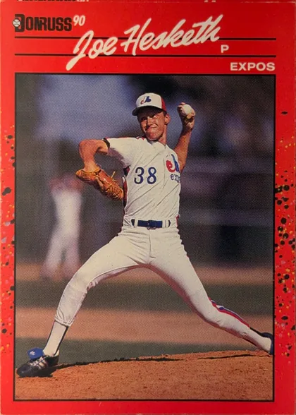 Front of 1990 Donruss Baseball Joe Hesketh #511, portrait baseball card front. A red speckled border surrounds a large central action photograph of a pitcher in an Expos uniform, wearing number 38…