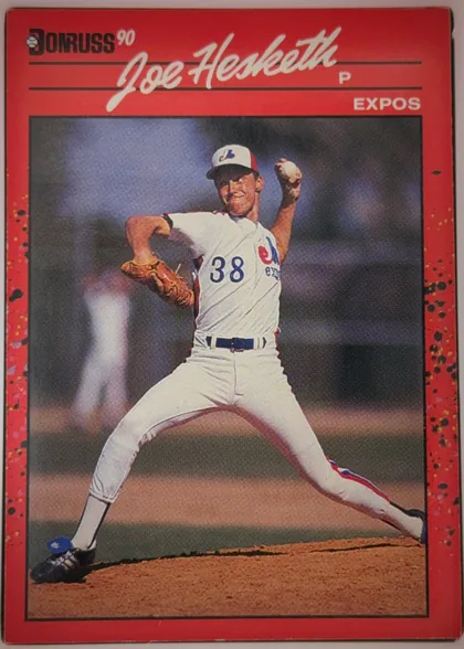 Front of 1990 Donruss Baseball Joe Hesketh #511, portrait-format baseball card front. A red header and border surround a large action photograph of a pitcher in a white Expos uniform. The Donruss…