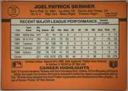 Back of 1990 Donruss Baseball Joel Skinner #73 Base, landscape-oriented baseball card back dominated by an orange field. The top section prints the player name in large black capitals, with a baseball…