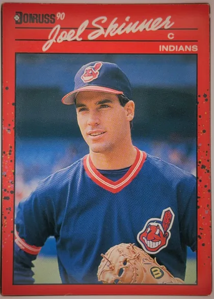 Front of 1990 Donruss Baseball Joel Skinner #73 Base, portrait-oriented baseball card front. A red border surrounds a large color photograph of Joel Skinner in a Cleveland Indians uniform holding a…