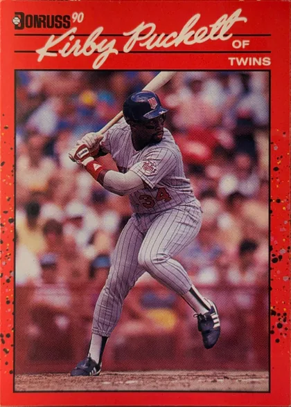 Front of 1990 Donruss Baseball Kirby Puckett #269, upright portrait baseball card front. The Donruss logo and small "90" appear at the upper left. Large white script reads "Kirby Puckett" across the…