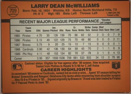 Back of 1990 Donruss Baseball Larry McWilliams #709 Base, back of a vertically oriented baseball card. The orange-brown background has black horizontal bands near the top and around a large light gray…