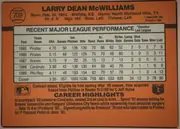 Back of 1990 Donruss Baseball Larry McWilliams #709 Base, landscape-oriented baseball card back with an orange-brown field. The player name appears prominently across the top, with card number 709 inside a…