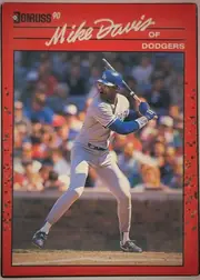 Front of 1990 Donruss Baseball Mike Davis #552, portrait-oriented baseball card front. A black Donruss logo and "90" appear at the upper left. The large white script name "Mike Davis" spans the…