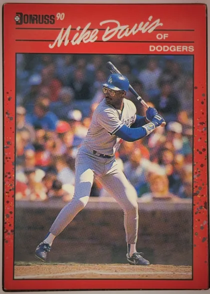 Front of 1990 Donruss Baseball Mike Davis #552 Base, upright portrait-format baseball card front. The upper red title area contains the Donruss logo and "90" at upper left, a large white script player…
