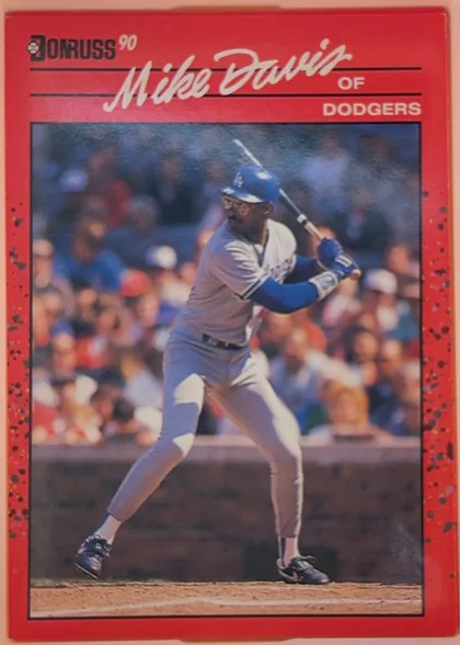 Front of 1990 Donruss Baseball Mike Davis #552, portrait baseball card front. A black-and-white Donruss logo and "90" appear at the upper left. The player's name, "Mike Davis," is displayed…