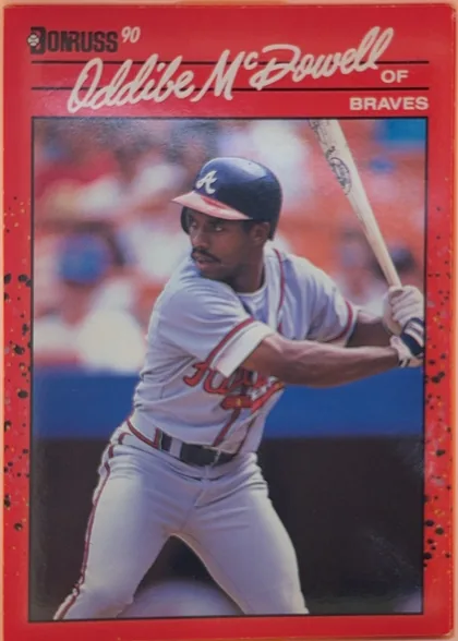 Front of 1990 Donruss Baseball ODDIBE McDOWELL, JR. #340, portrait baseball card front. A red border surrounds a large action photograph of a Braves batter holding a bat. The Donruss 90 logo is at the upper…