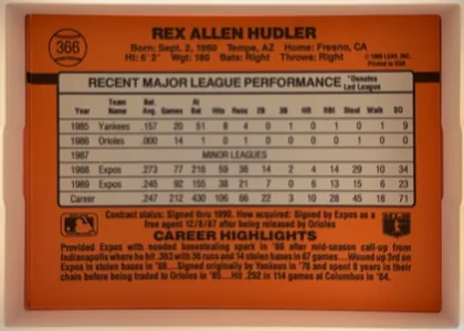 Back of 1990 Donruss Baseball Rex Hudler #366, landscape-oriented baseball card back dominated by an orange-red field. The player name is centered across the top, with a baseball-shaped number…