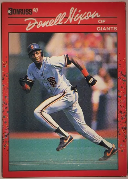 Front of 1990 Donruss Baseball ROBERT DONELL NIXON #571, portrait baseball card front. A large central action photograph shows a San Francisco Giants player in a gray uniform running. The top red header…